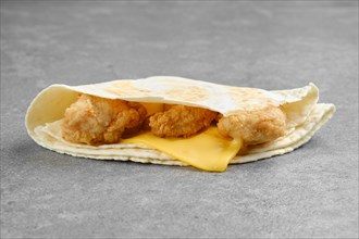 Flatbread stuffed with chicken fillet in breading with melted cheddar cheese