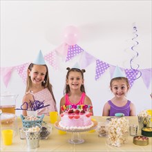 Portrait smiling kids wearing party hat celebrating birthday party