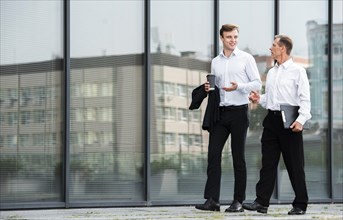 Businessmen having conversation while walking