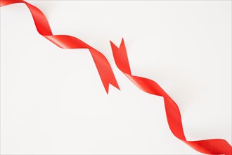 Curled red ribbons white background