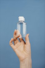 Close up hand with hand sanitizer bottle