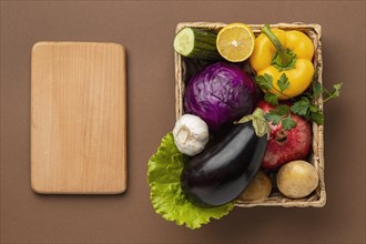 Flat lay basket fresh vegetables with chopping board