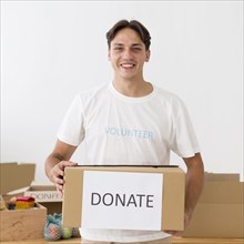 Happy volunteer holding donate box