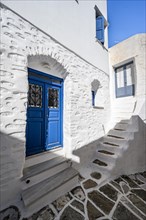 White Cycladic houses with blue doors and windows