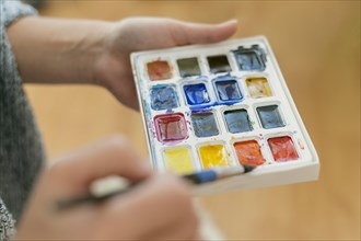 Close up artist holding color palette