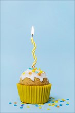 Sweet cupcake with lit candle