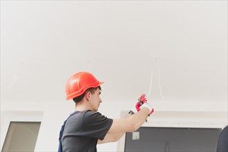 Man working with cables ceiling