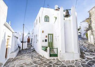 White Cycladic houses with green windows and doors