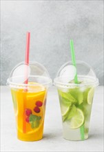 Front view cups with soft drinks straws