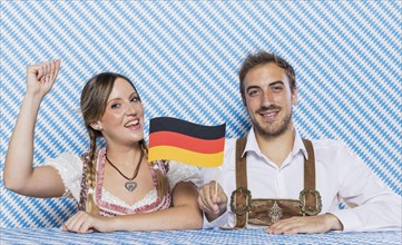 Bavarian friends holding german flag