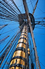 Masts of old wooden Age of sail sailing ship with ropes cordage and shroud and crow's nest