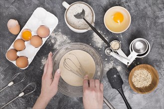 Close up female s hand preparing bread ingredients concrete backdrop