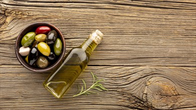 Assortment colorful olives with oil bottle copy space