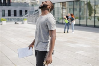 Laughing black man with papers