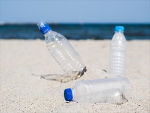 Plastic waste empty bottle sand beach