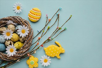 Flat lay easter eggs basket with chamomile flowers