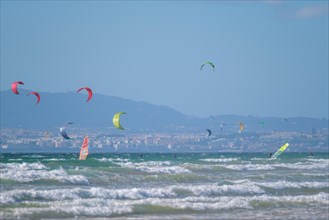 Kiteboarding kitesurfing kiteboarder kitesurfer kites on the Atlantic ocean beach at Fonte da Telha beach