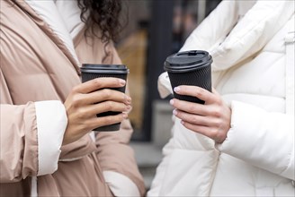 Close up hands holding coffee cups