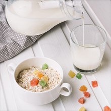 Overhead view oatmeal with glass milk white table