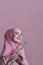 Muslim woman playing flute