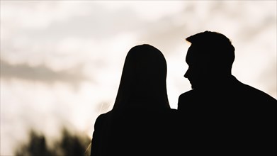 Silhouette couple against sky evening