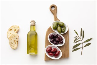 Flat lay bread slices purple red green olives with olive oil bottle