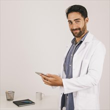 Happy medical doctor working with ipad