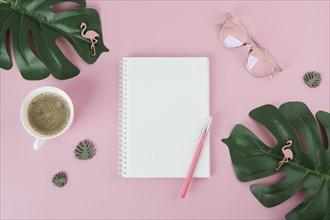 Blank notebook with pen pink table