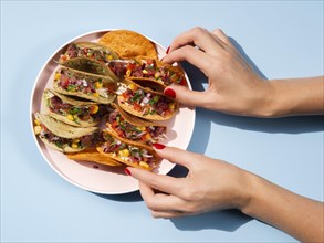 Woman with plate full tacos