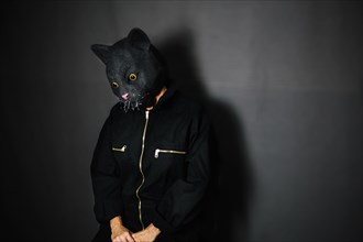 Person cat mask dark room