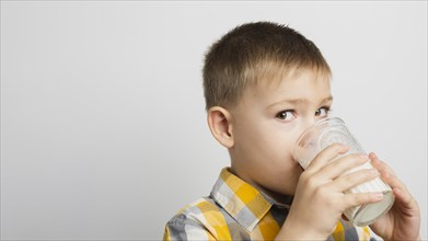 Boy drinking milk with glass
