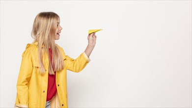 Side view girl with paper airplane