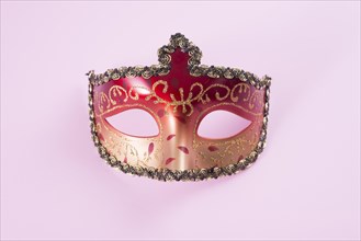 Red carnival mask pink table