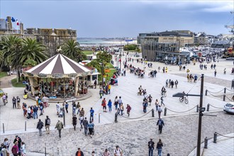 Square in front of the city gate Porte St Vincent with carousel Manege and tourist information in Saint Malo