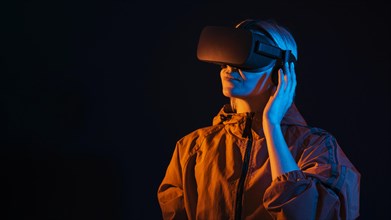 Medium shot smiley woman experiencing virtual reality