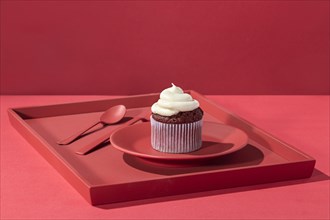 High angle cupcake with cream plate