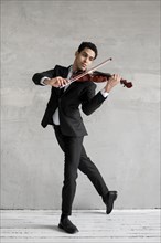 Male musician dancing playing violin