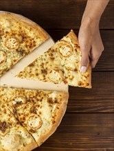 Flat lay hand taking slice pizza with cheese