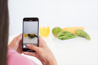 Girl taking picture vegetable