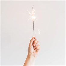 New year composition with hand holding sparkler