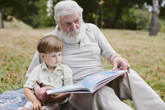 Grandpa grandson park reading