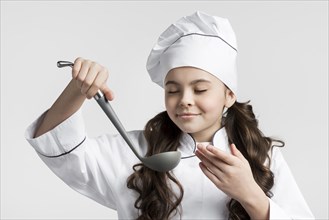 Portrait young girl holding soup ladle