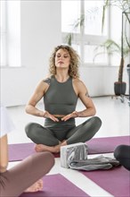 Yoga teacher leading practitioners