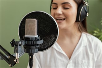 Female musician singing into microphone