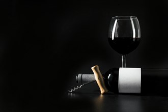 Corkscrew bottle near wineglass