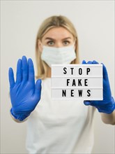Stop fake news woman wearing gloves