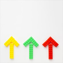 Top view colored toy arrows pointing up