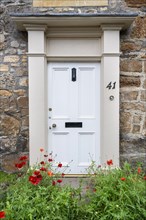 White front door on an old stone house