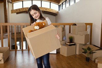 Girl holding box with toy medium shot
