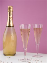 Champagne bottle with filled glasses